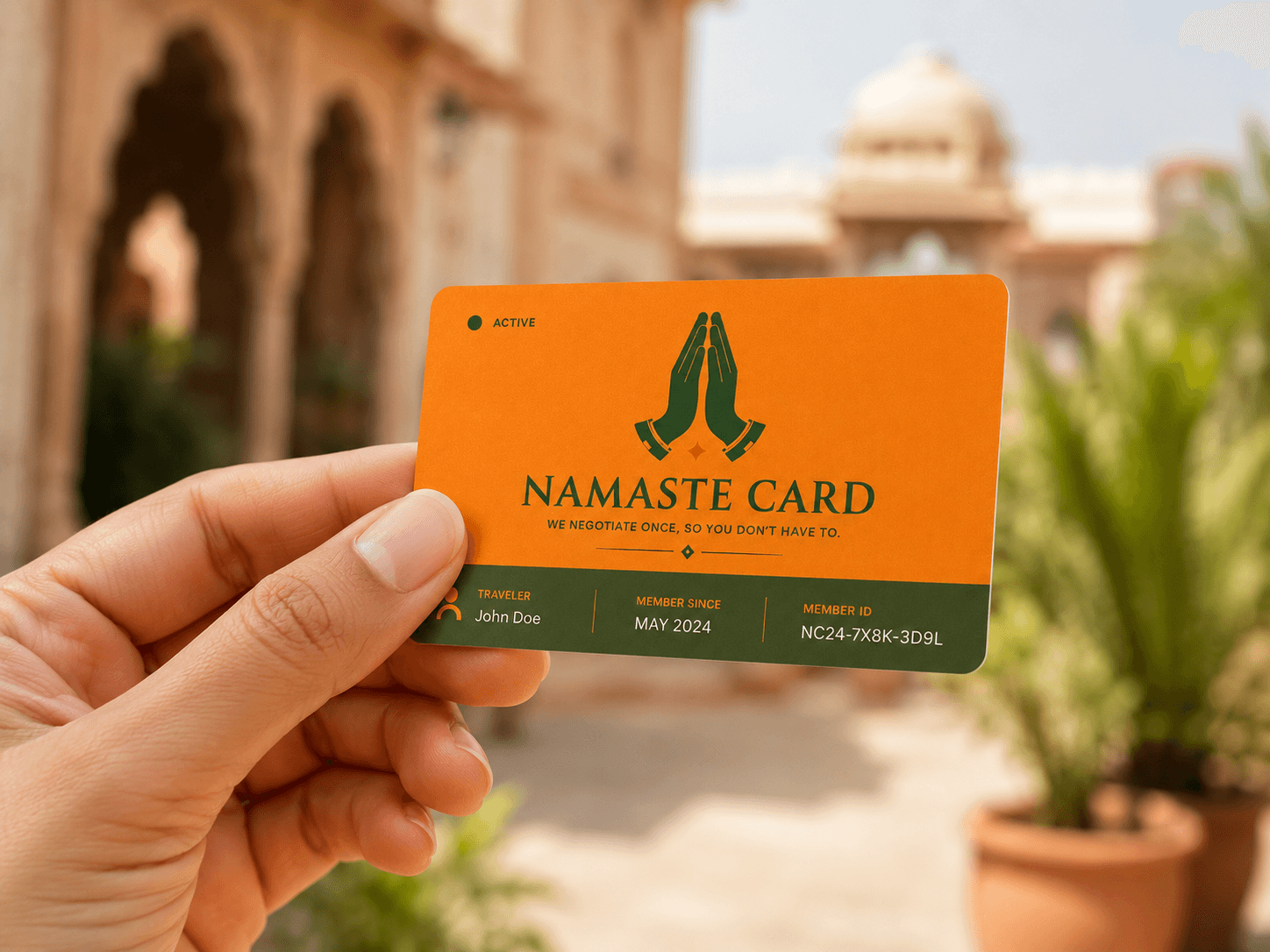 A traveler holding the orange Namaste Card in a sunlit Indian courtyard